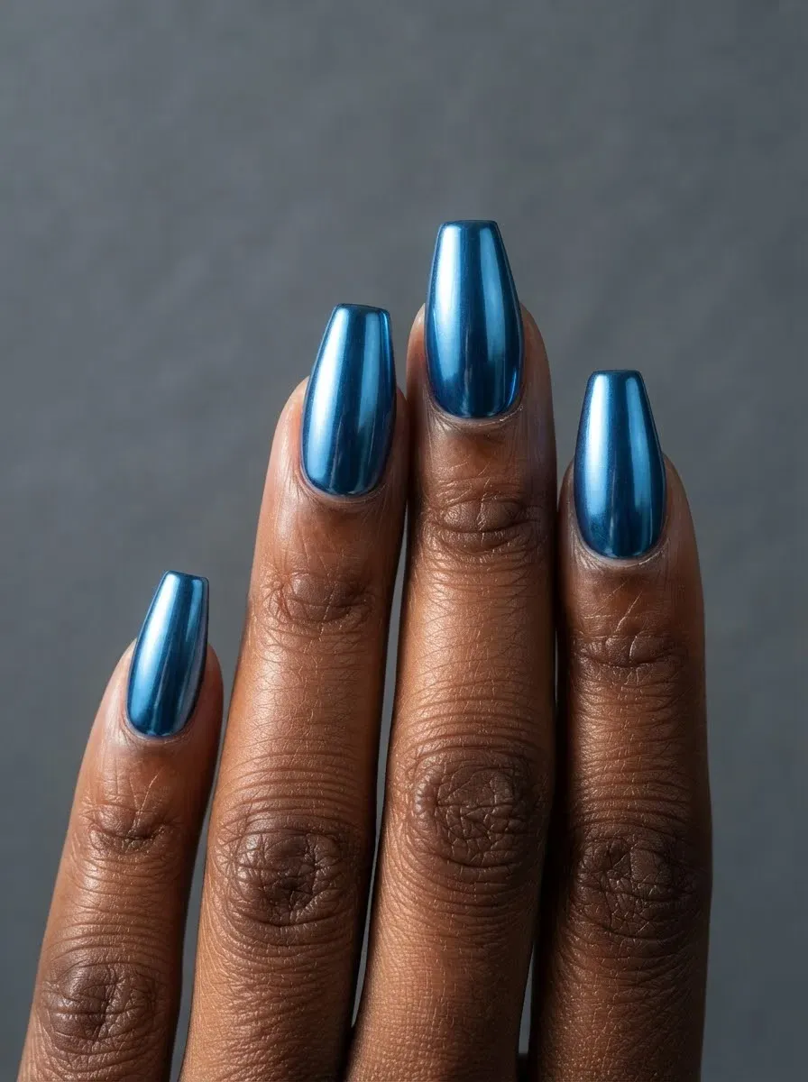 Close-up of coffin nails in blue chrome on deep chestnut skin