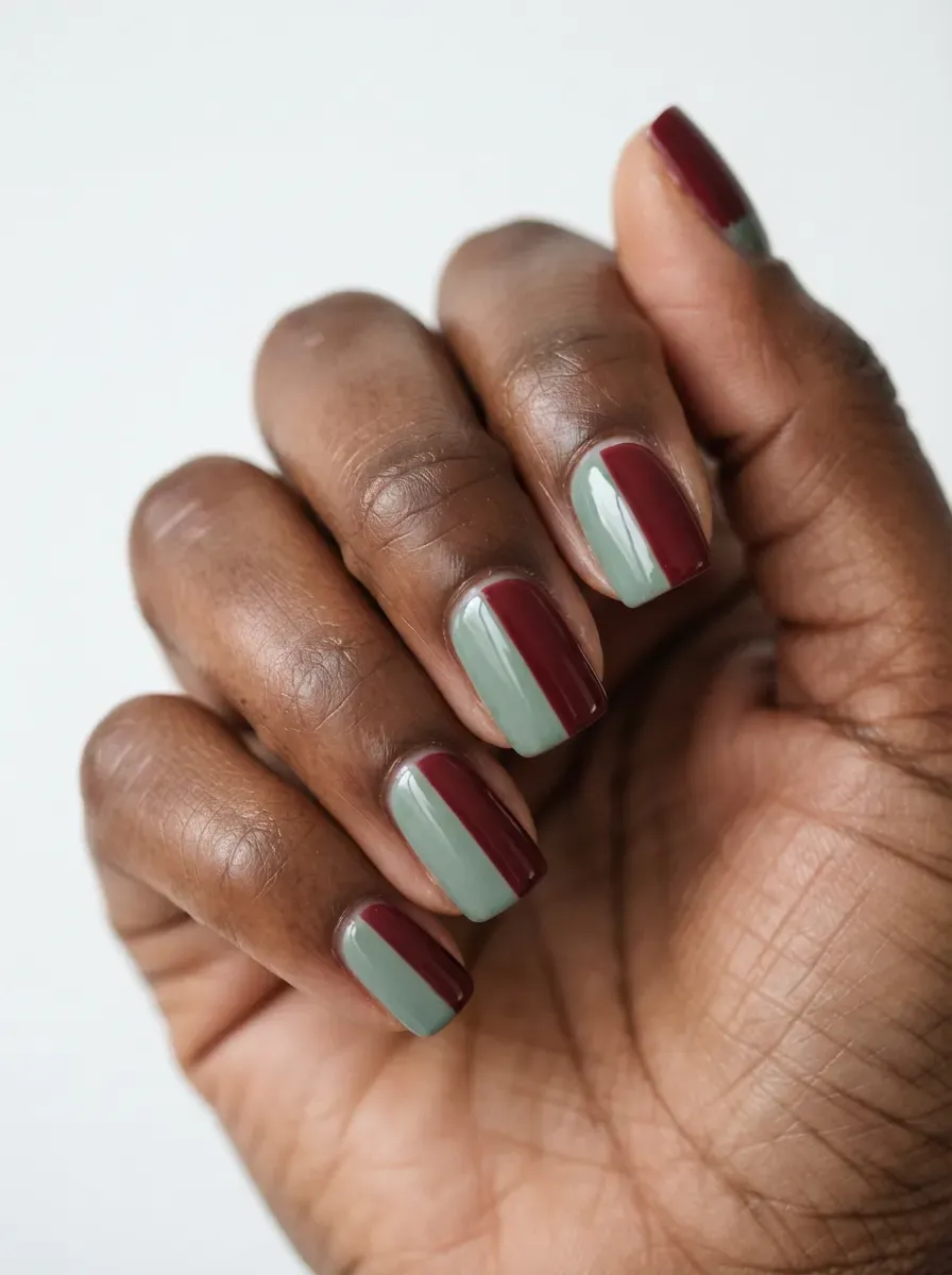 Close-up of medium oval nails with burnished copper cat-eye magnetic polish on deep chestnut skin