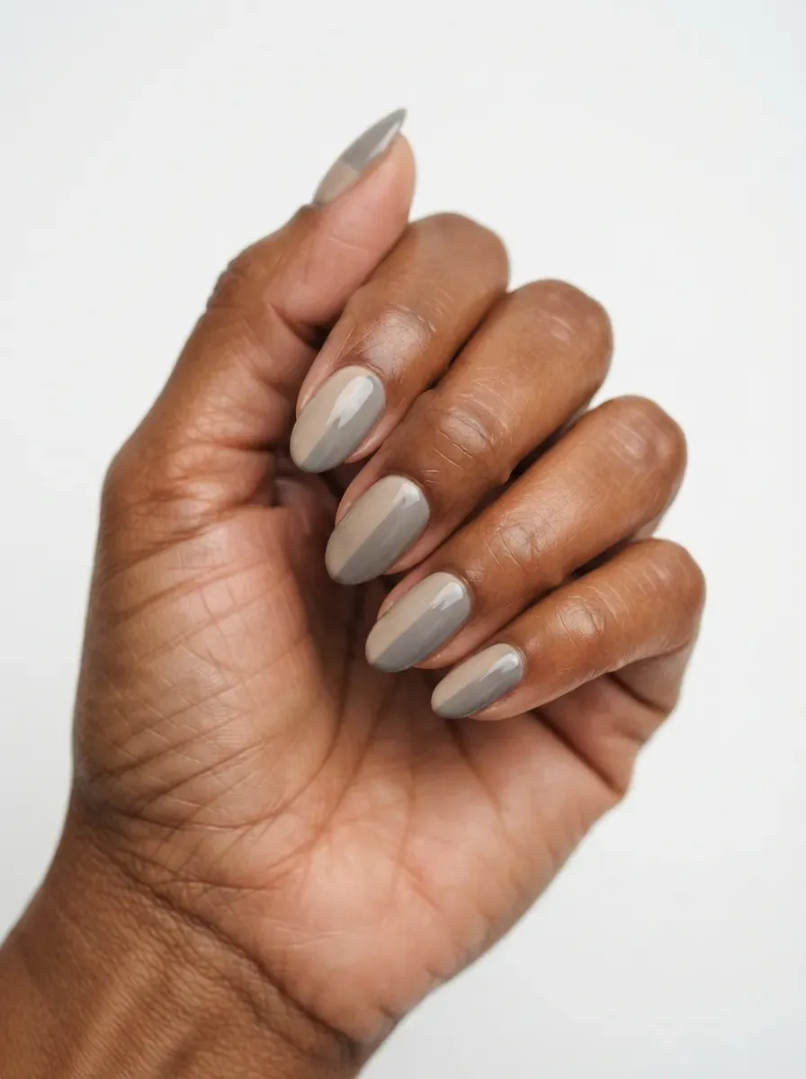 Close up of almond nails in greige polish with a smooth high gloss finish