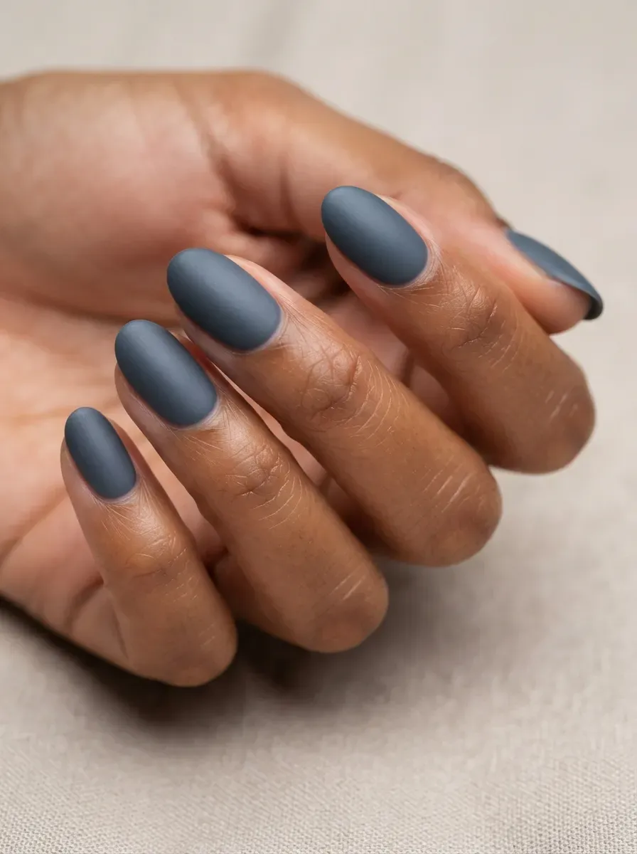 Close-up of nails with cool slate velvet undertones on warm brown skin